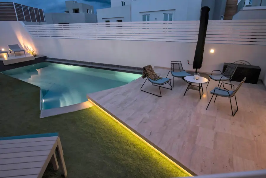 Pool and timber deck of the Linux home at dusk